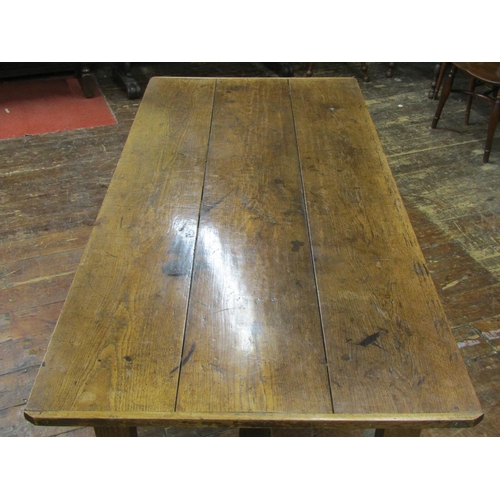 2753 - An antique oak kitchen farmhouse table, the planked top with cleated ends raised on four square tape... 