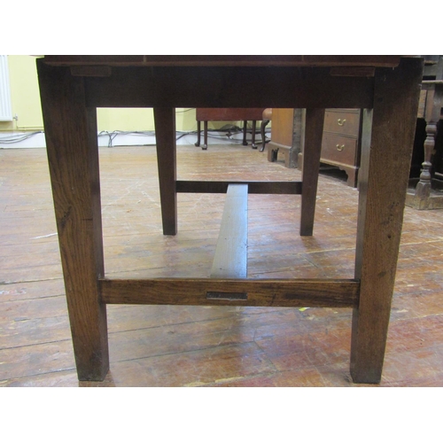 2753 - An antique oak kitchen farmhouse table, the planked top with cleated ends raised on four square tape... 