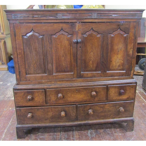 2761 - A Welsh livery cupboard, the lower section enclosed by five drawers, the upper by two panelled doors... 