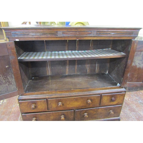 2761 - A Welsh livery cupboard, the lower section enclosed by five drawers, the upper by two panelled doors... 