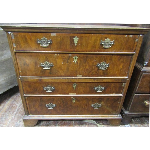 2764 - An antique countrymade chest of four long drawers, the carcass in two sections with figured walnut f... 