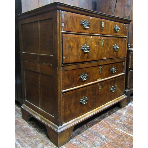 2764 - An antique countrymade chest of four long drawers, the carcass in two sections with figured walnut f... 