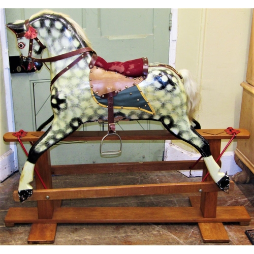 2766 - A traditional rocking horse with dapple grey paintwork, leather saddlery, raised on a central stretc... 