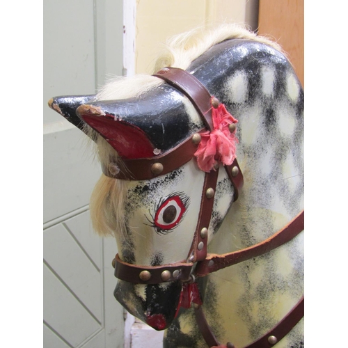 2766 - A traditional rocking horse with dapple grey paintwork, leather saddlery, raised on a central stretc... 