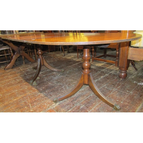 2772 - A Georgian style mahogany D end extending dining table raised on twin pillars and quadruped supports... 