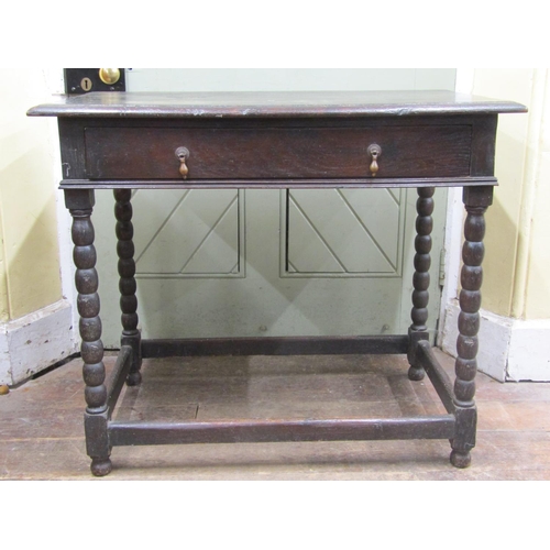 2781 - An early Georgian oak side table with frieze drawer on bobbin moulded supports, 90cm wide