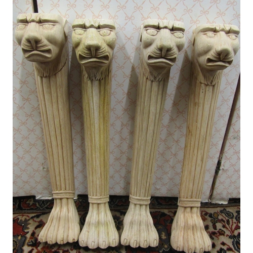 2691 - Four carved hardwood column supports with lion mask and lions paw feet, 58cm high