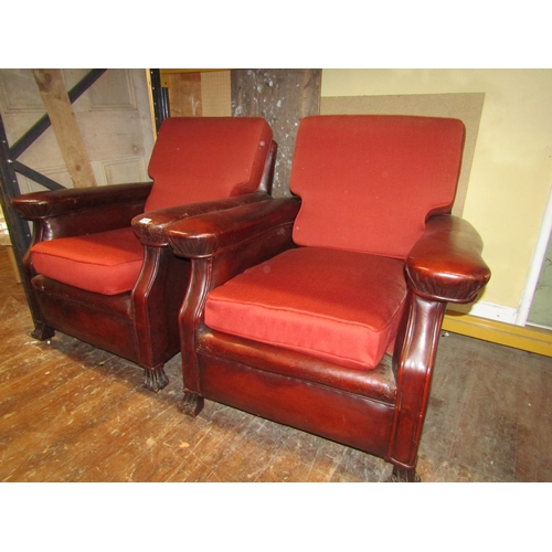 2701 - A pair of late Edwardian club chairs, the framework upholstered in maroon leather with later upholst... 