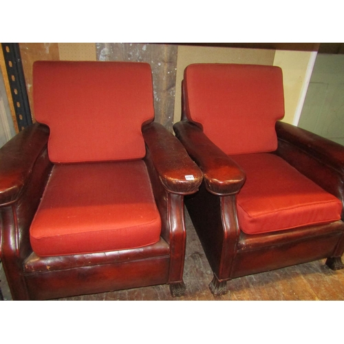 2701 - A pair of late Edwardian club chairs, the framework upholstered in maroon leather with later upholst... 