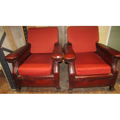 2701 - A pair of late Edwardian club chairs, the framework upholstered in maroon leather with later upholst... 