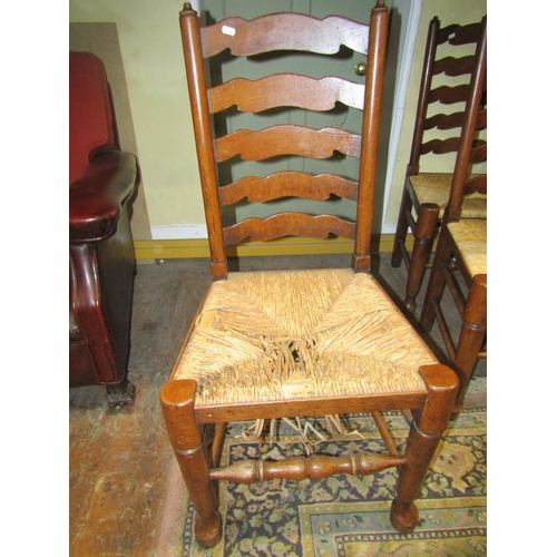 2702 - A set of six (2&4) ladderback dining chairs of traditional form with rush seats