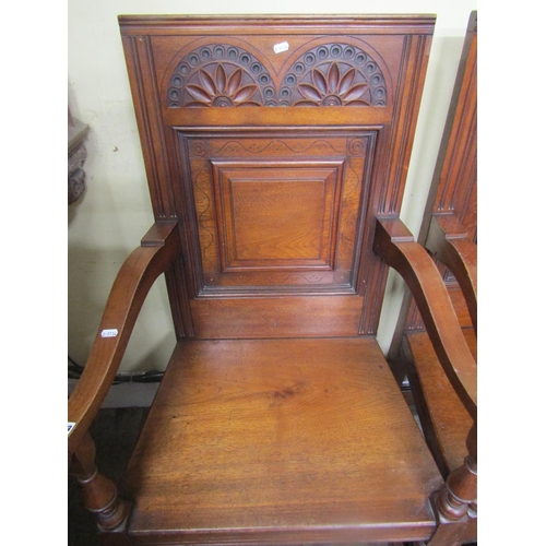 2783 - A pair of Victorian oak Wainscot chairs the panelled backs with carved detail, solid seats and swept... 