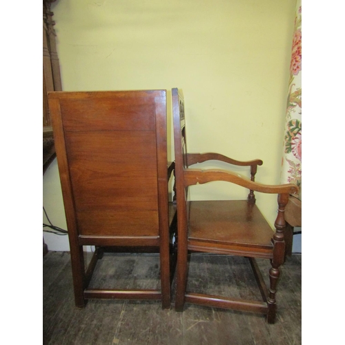 2783 - A pair of Victorian oak Wainscot chairs the panelled backs with carved detail, solid seats and swept... 