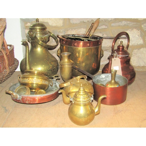 2153 - A collection of antique and later copper and brassware to include two outsized kettles with loop han... 