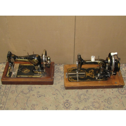 2174 - Two vintage portable cased sewing machines, Stoewer & Singer examples with decorative transfer print... 