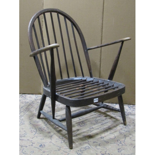 2178 - A vintage Ercol dark stained beechwood hoop and stick back open armchair with sprung seat (af)