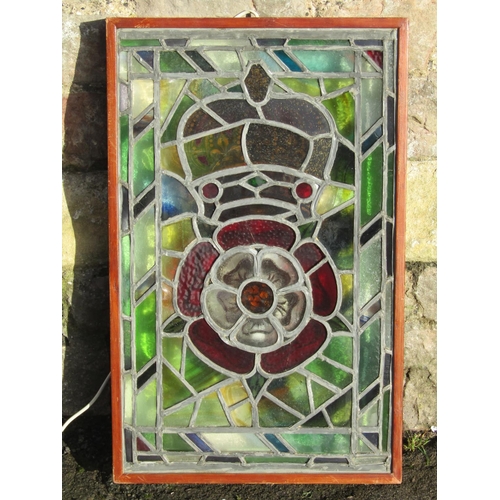 2454 - A rectangular stained glass panel with rose and crown detail, framed in a light box 71 cm x 45 cm (o... 