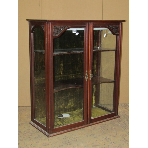 2466 - An Edwardian walnut table top display cabinet enclosed by a pair of glazed panelled doors with reede... 