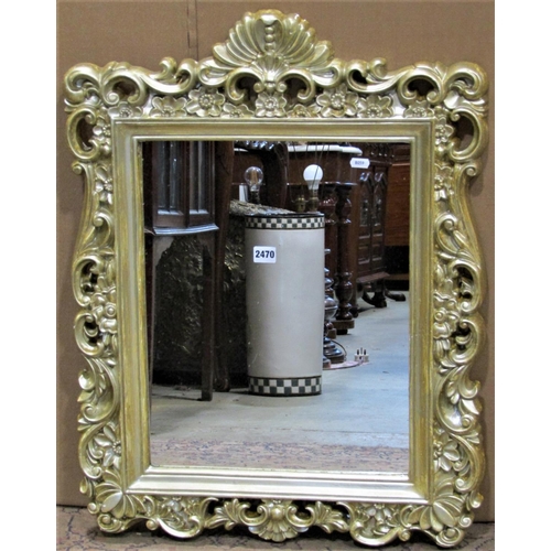 2470 - A composite gilt framed wall mirror with decorative C scroll and repeating floral detail, 58 cm x 76... 