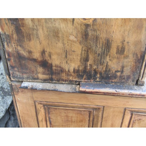 2409 - A 19th century stripped pine farmhouse kitchen dresser, the base partially enclosed by a pair of mou... 