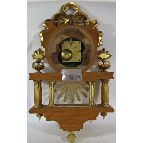 1513 - A gilded wall clock the decorative casework with column, floral and ribbon detail enclosing an eight... 