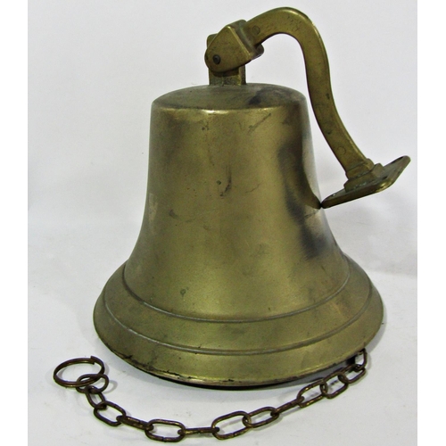 A wall hung brass bell with clapper