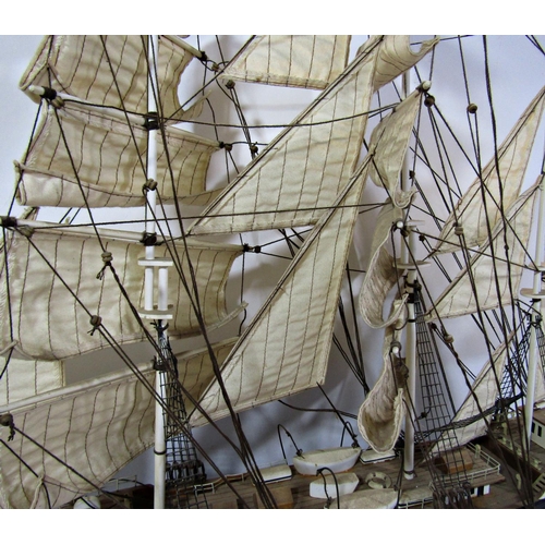 1800 - A wooden model of a three masted sailing ship in full sail, on a wooden stand, 79cm long x 67cm high