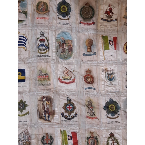 1633 - Early 20th century panel featuring a large collection of WW1 cigarette silks of regiments, flags, mi... 