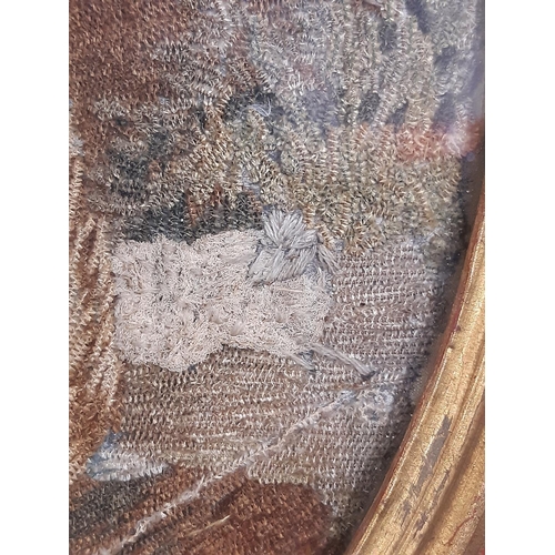 38 - Georgian silk needlework of a young lady in gilt oval frame and glazed, 24 x 18 cm