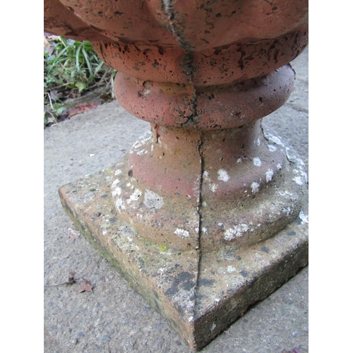 2004 - A pair of weathered cast composition stone garden urns, set on socles with square bases, 40 cm diame... 