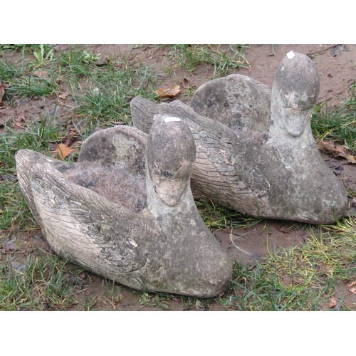 2008 - A matched pair of novelty weathered cast composition stone garden planters in the form of swans, 30 ... 