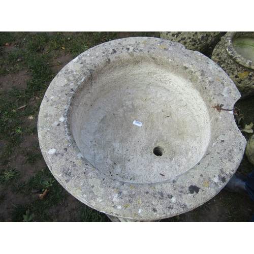 2012 - A weathered cast composition stone circular lobbed garden urn and combined socle raised on an associ... 