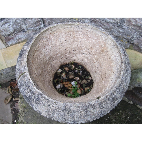 2031 - A weathered cast composition stone garden urn, raised on square based socle, approx 60 cm diameter x... 