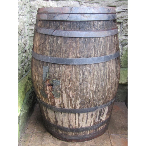 2040 - A weathered coopered oak and steel banded beer or cider barrel 98 cm high (af)