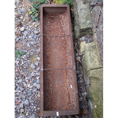 2057 - A vintage cast iron pig feeding trough of rectangular form with two simple rung divisions 96 cm long... 