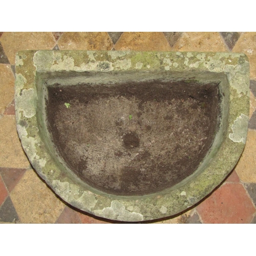 2062 - A weathered natural stone D shaped trough with drainage hole, 57 cm wide x 42 cm x 20 cm high