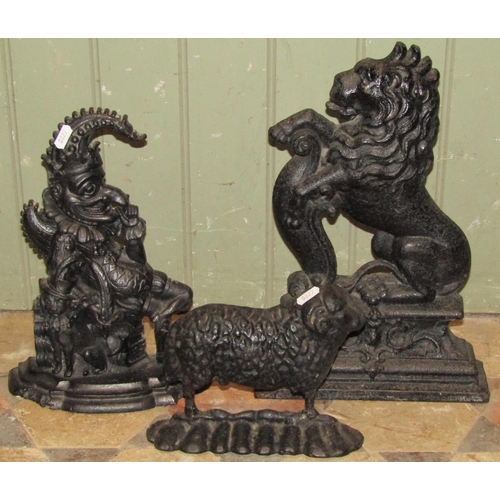 2087 - Three 19th century cast iron door porters, rampant lion, Mr Punch and ram