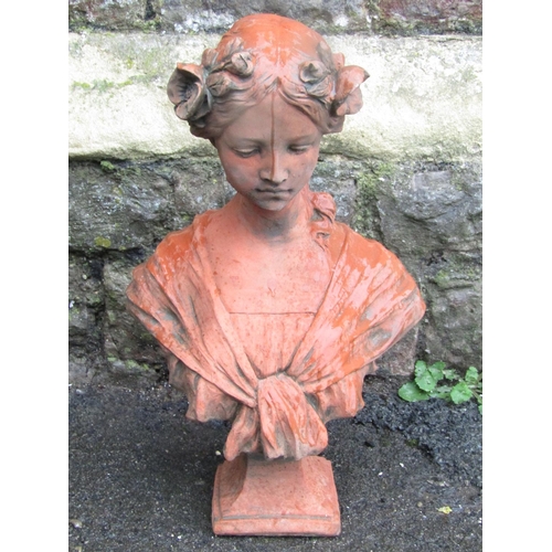 2106 - A cast composition stone head and shoulder bust of a maiden with faux terracotta finish, 47 cm high