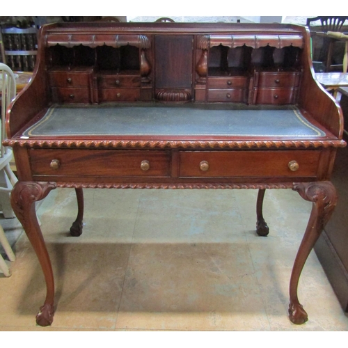 2192 - A reproduction mahogany writing desk with inset leather top fitted with an arrangement of small draw... 