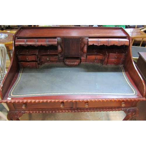 2192 - A reproduction mahogany writing desk with inset leather top fitted with an arrangement of small draw... 