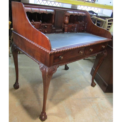 2192 - A reproduction mahogany writing desk with inset leather top fitted with an arrangement of small draw... 