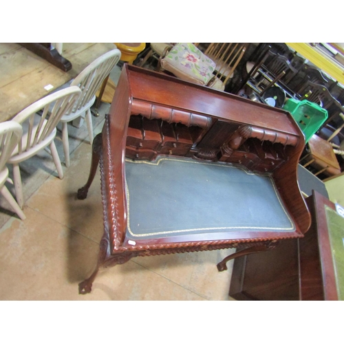 2192 - A reproduction mahogany writing desk with inset leather top fitted with an arrangement of small draw... 