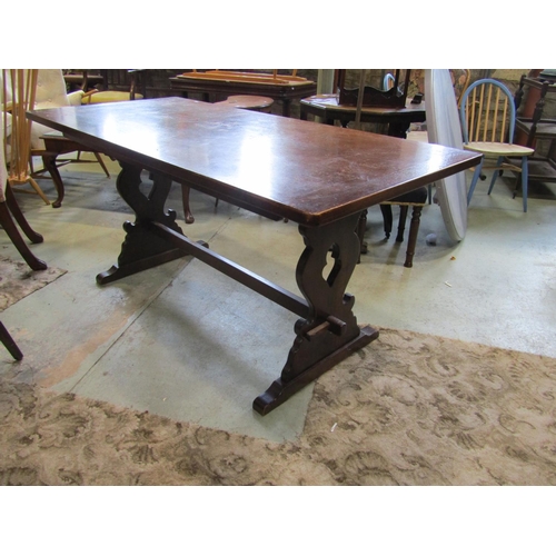 2209 - An oak refectory table raised on pierced lyre shaped supports with sledge feet, united by central pe... 