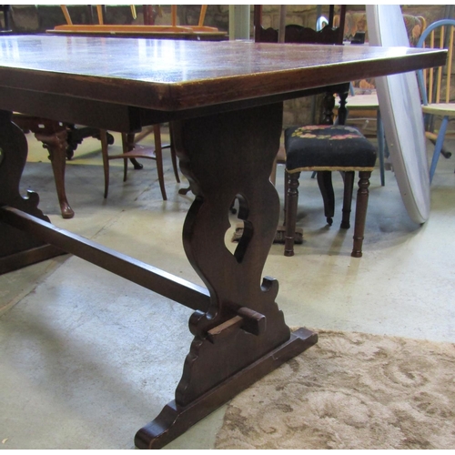 2209 - An oak refectory table raised on pierced lyre shaped supports with sledge feet, united by central pe... 