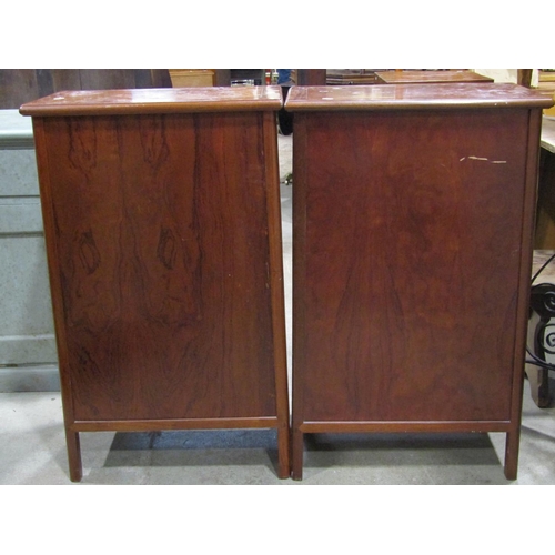 2237 - A pair of dwarf Chinese side cabinets of tapered form, each enclosed by a pair of rectangular moulde... 