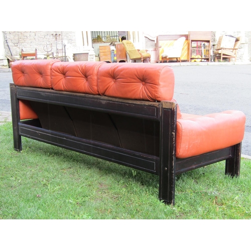 2690 - A contemporary three seat sofa with ebonised frame, upholstered and buttoned in leather, 2m wide