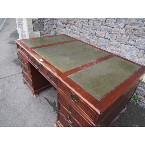 2789 - A reproduction Georgian mahogany writing desk with eight drawers, the top with inset olive green lea... 