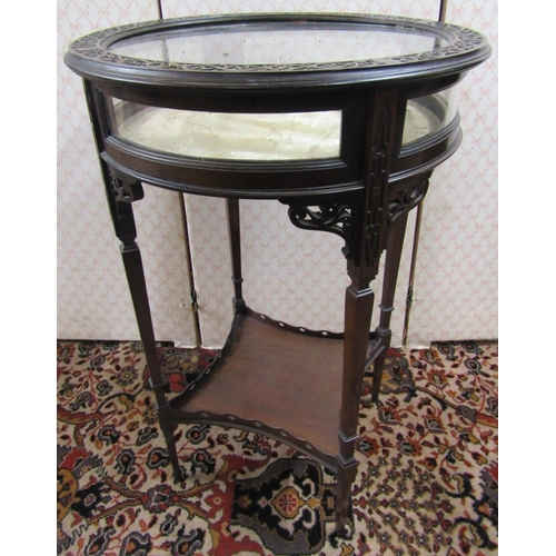 2791 - An Edwardian vitrine of circular form with rising lid, raised on four tapered supports, with pierced... 