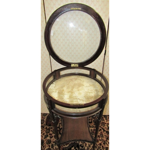 2791 - An Edwardian vitrine of circular form with rising lid, raised on four tapered supports, with pierced... 