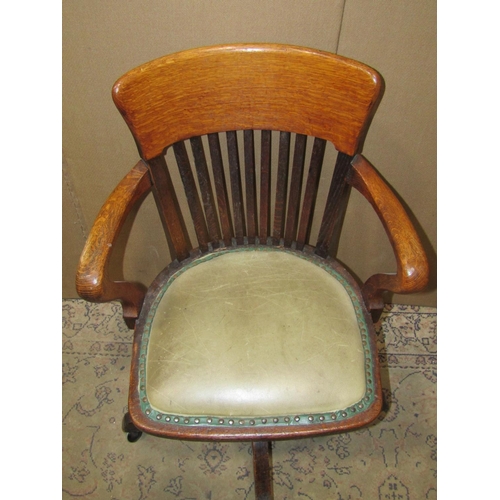 2183A - An Edwardian/1920's oak swivel office chair with pad seat